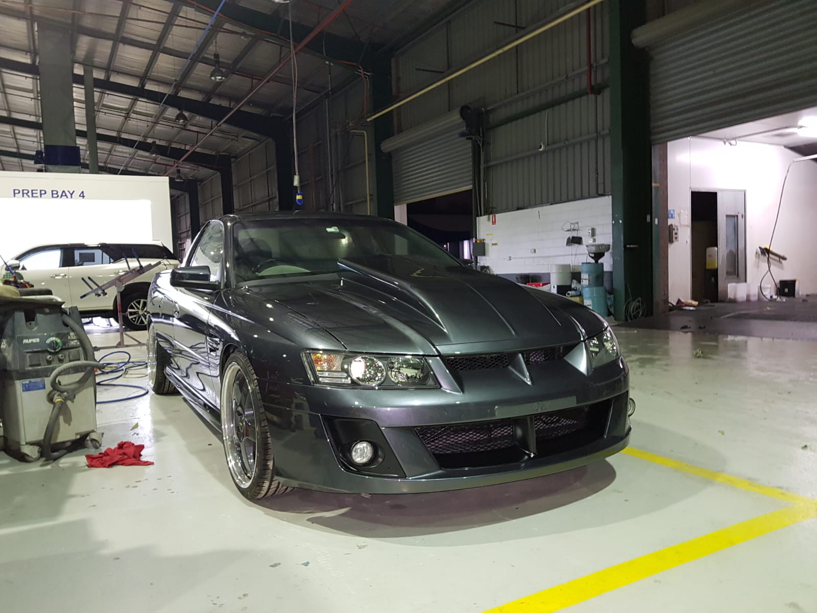 Vehicle in workshop prep bay 4 — surface preparation before spray painting at MRP Automotive